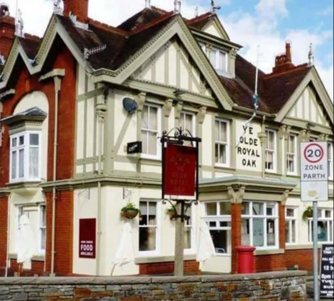The Royal Oak's Victorian frontage on Commercial Street: cream render, dark timbering and the red hanging sign.