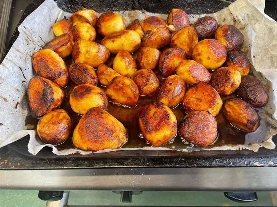 A tray of roast potatoes fresh out of the oven.